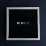 Black letter board with the word 'CLOSED' in white on a dark background.