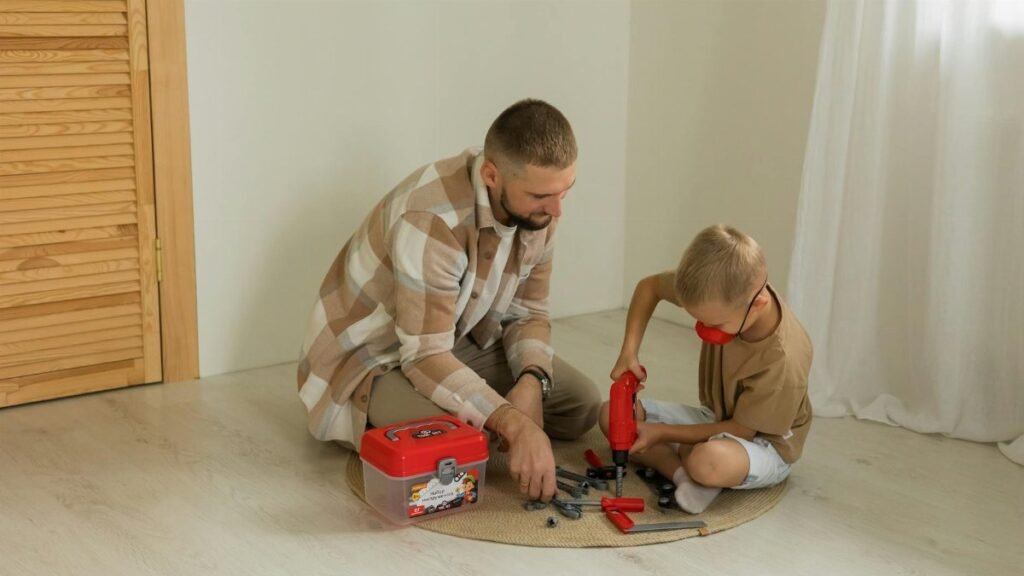 A father and son bonding over a building project with toy tools on a rug indoors.