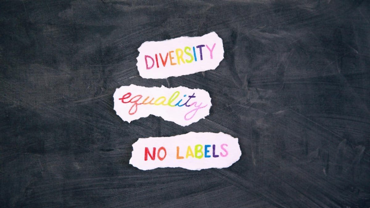 Colorful words highlighting diversity, equality, and no labels on a chalkboard background.