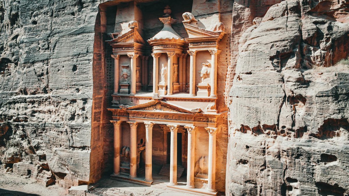 The iconic Treasury in Petra, Jordan, carved into striking sandstone cliffs, captures ancient Nabatean beauty.