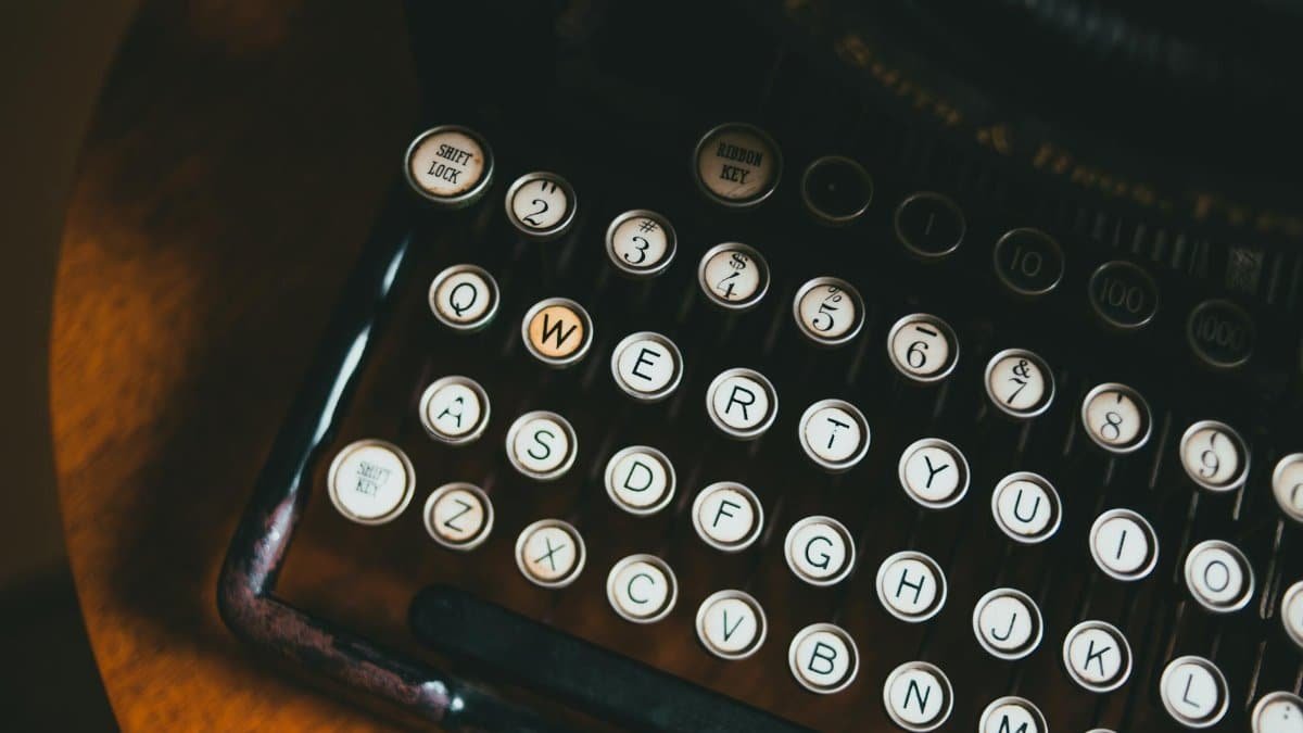 Close-up image of a vintage typewriter keyboard, showcasing classic round keys and retro design.