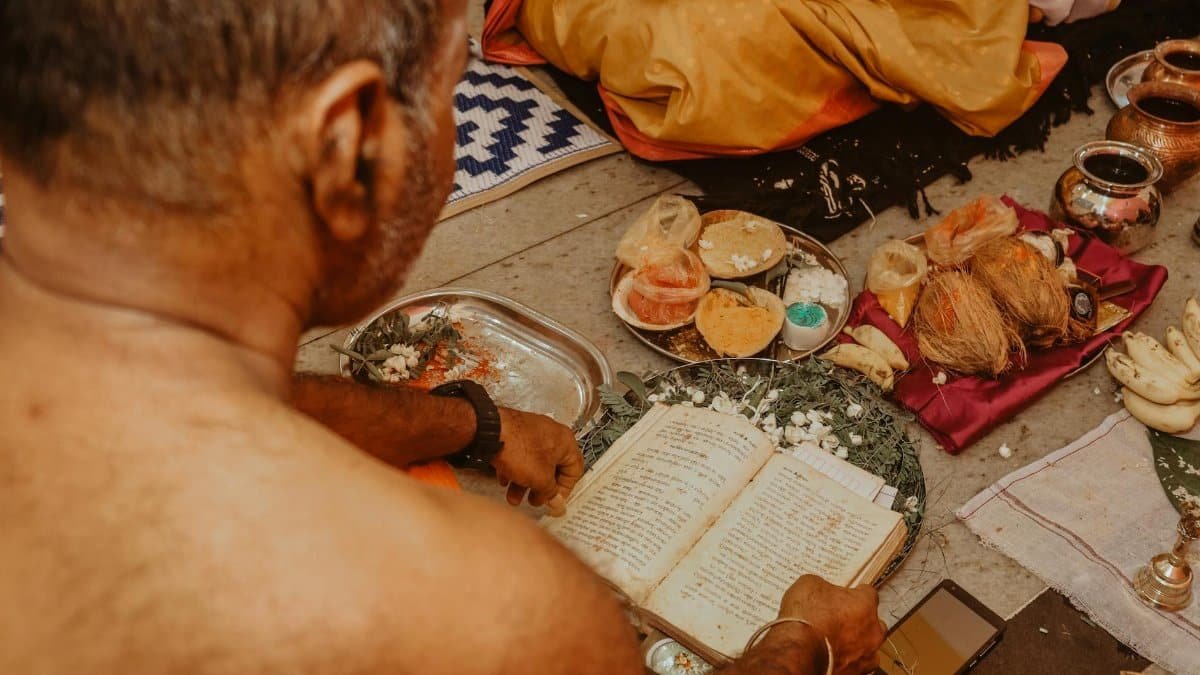 An intimate view of a traditional ceremony with ritual offerings and sacred texts.