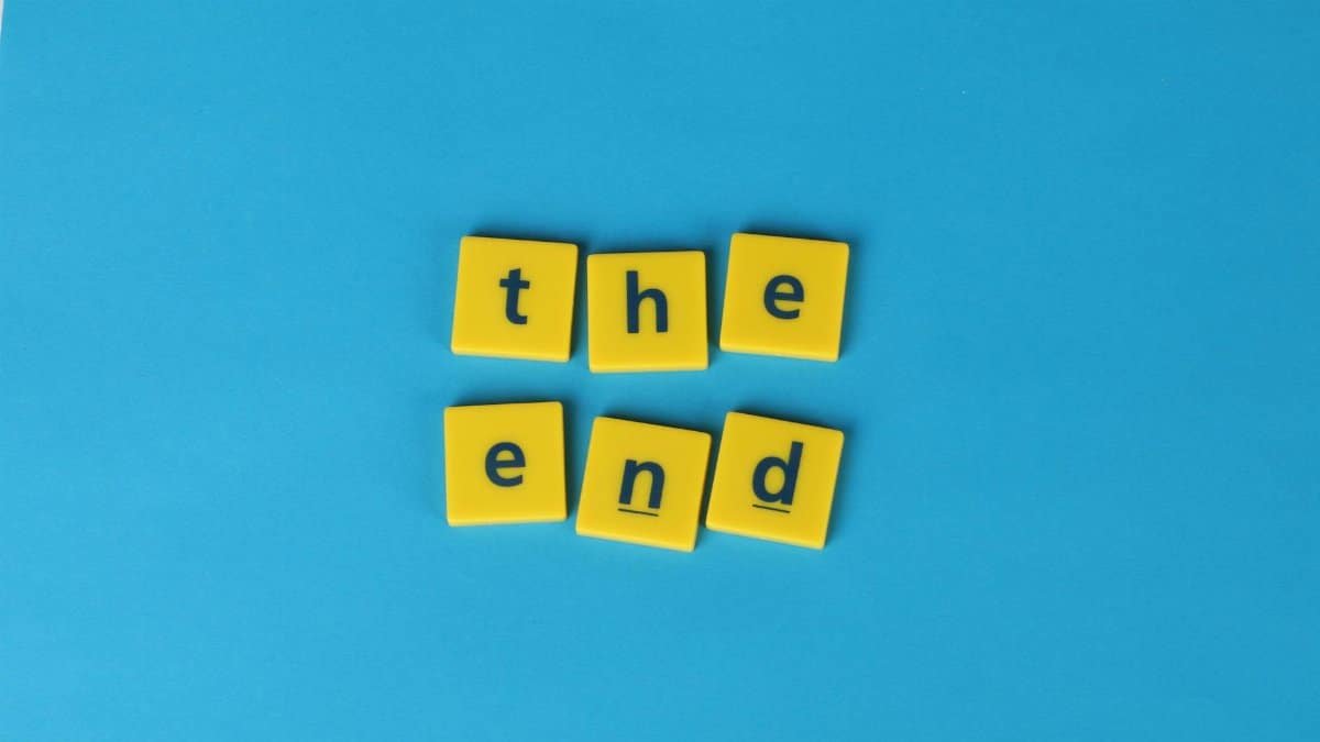 Yellow letter tiles spelling 'the end' on a vibrant blue background create a striking visual.