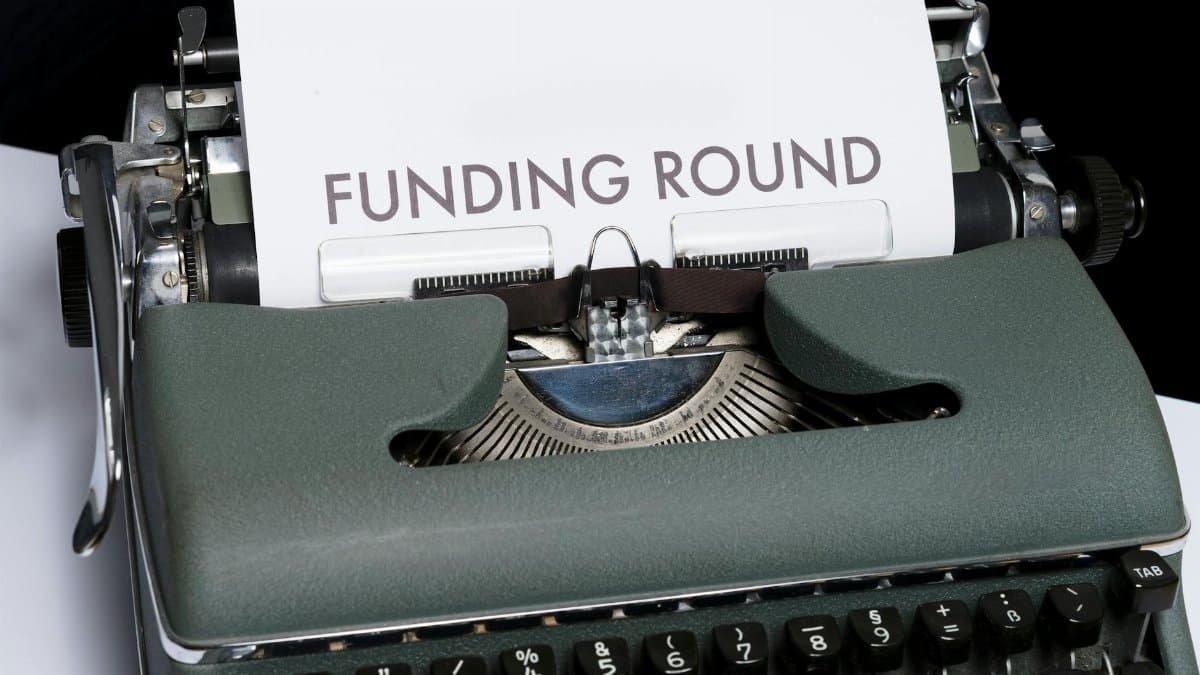 A vintage typewriter displaying the text 'Funding Round,' symbolizing investment and business planning.