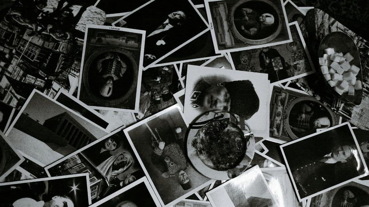 Top view black and white of assorted photos on desk with glass bowl at home
