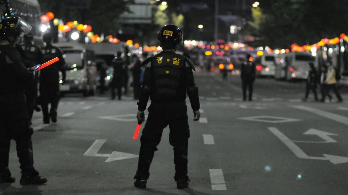 Police officers maintaining order during a night street patrol, ensuring public safety.