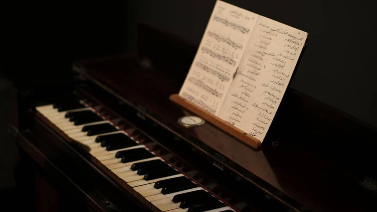 A close-up of a vintage piano with sheet music, highlighting its nostalgic charm.