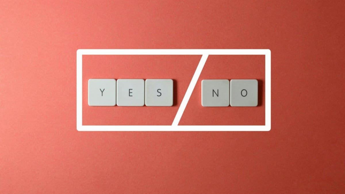 Creative concept of decision making with YES and NO keys on a red background.