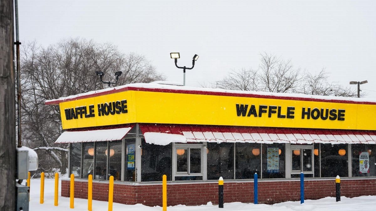 A Waffle House building covered in snow, showcasing winter atmosphere and architecture.