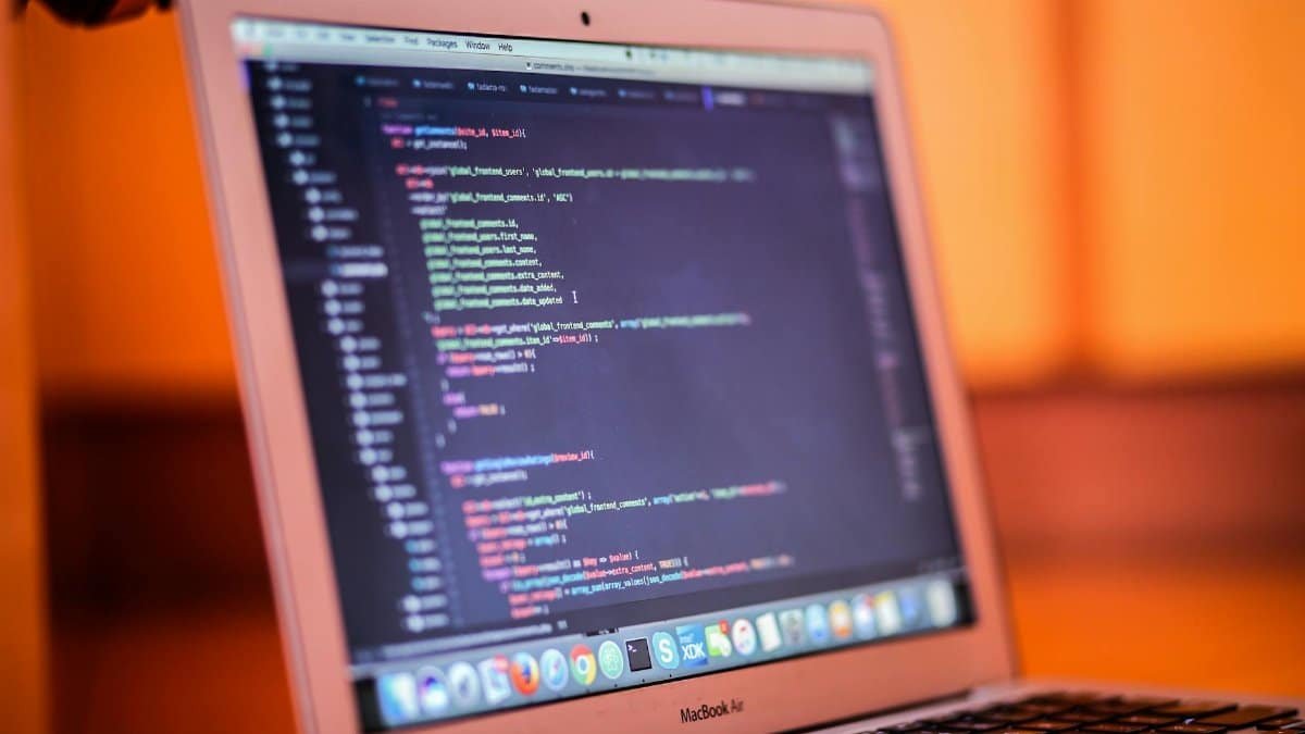 Focused shot of a laptop displaying code, suitable for tech and coding themes.