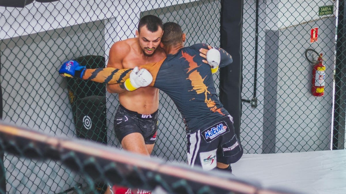Two male fighters engaged in an MMA match demonstrating strength and agility.