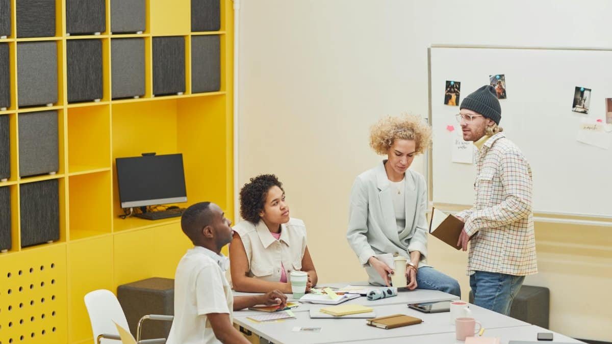 A diverse team holds a collaborative meeting in a modern office setting.