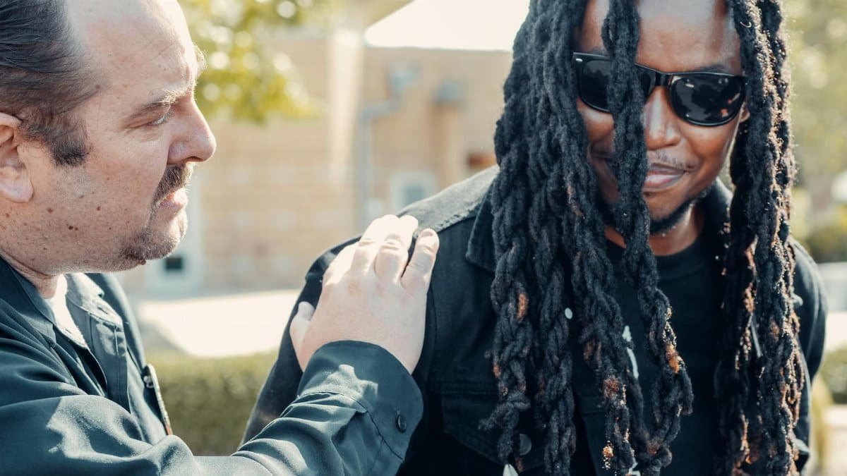 A police officer engaging in positive community interaction outdoors.
