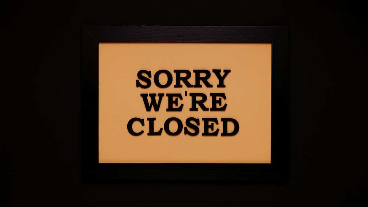 Black-framed 'Sorry We're Closed' sign against a dark backdrop, ideal for business themes.