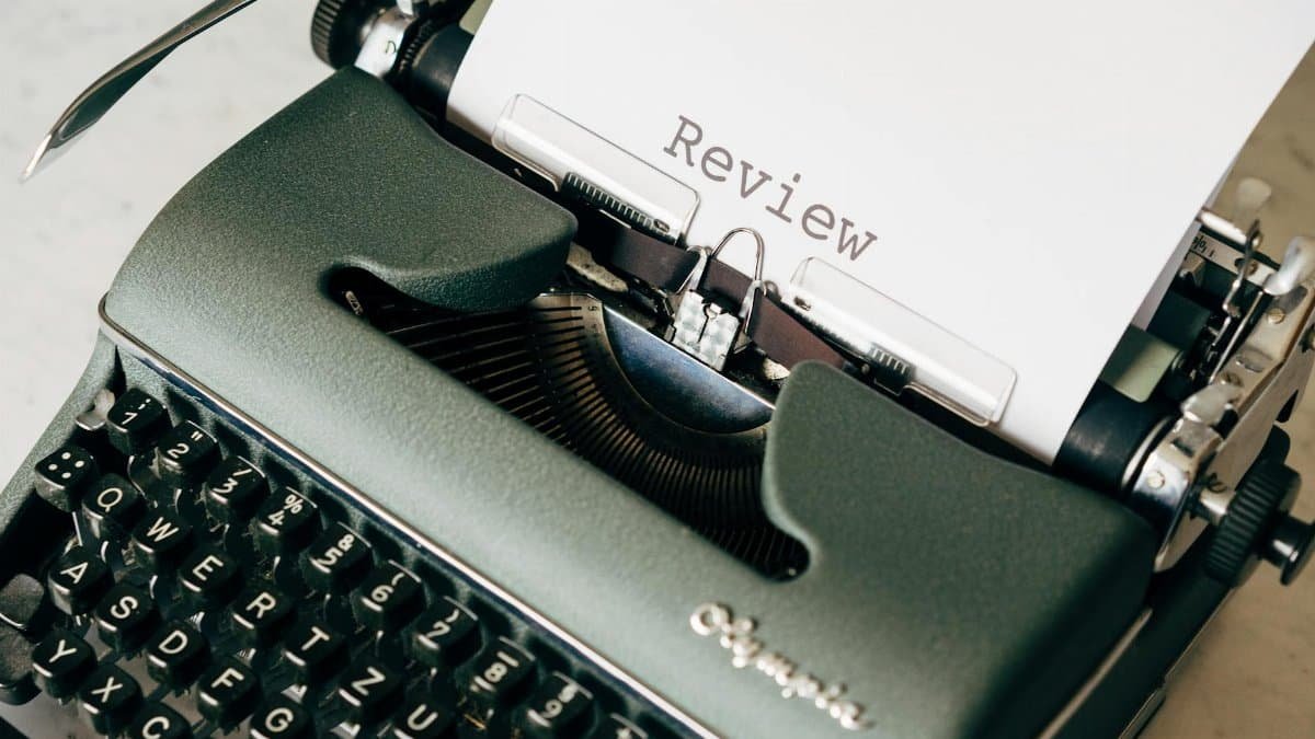 Classic green typewriter with paper displaying 'Review', perfect for creative writing themes.