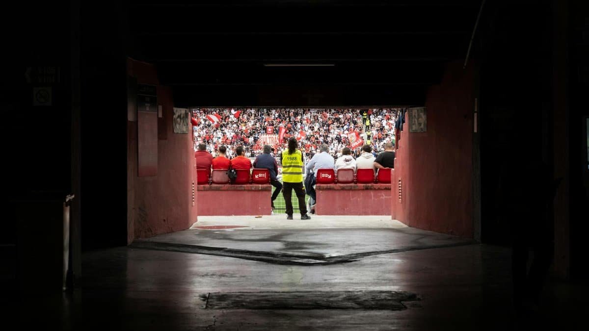 A dynamic stadium perspective through the tunnel showcasing engaged spectators during a game.