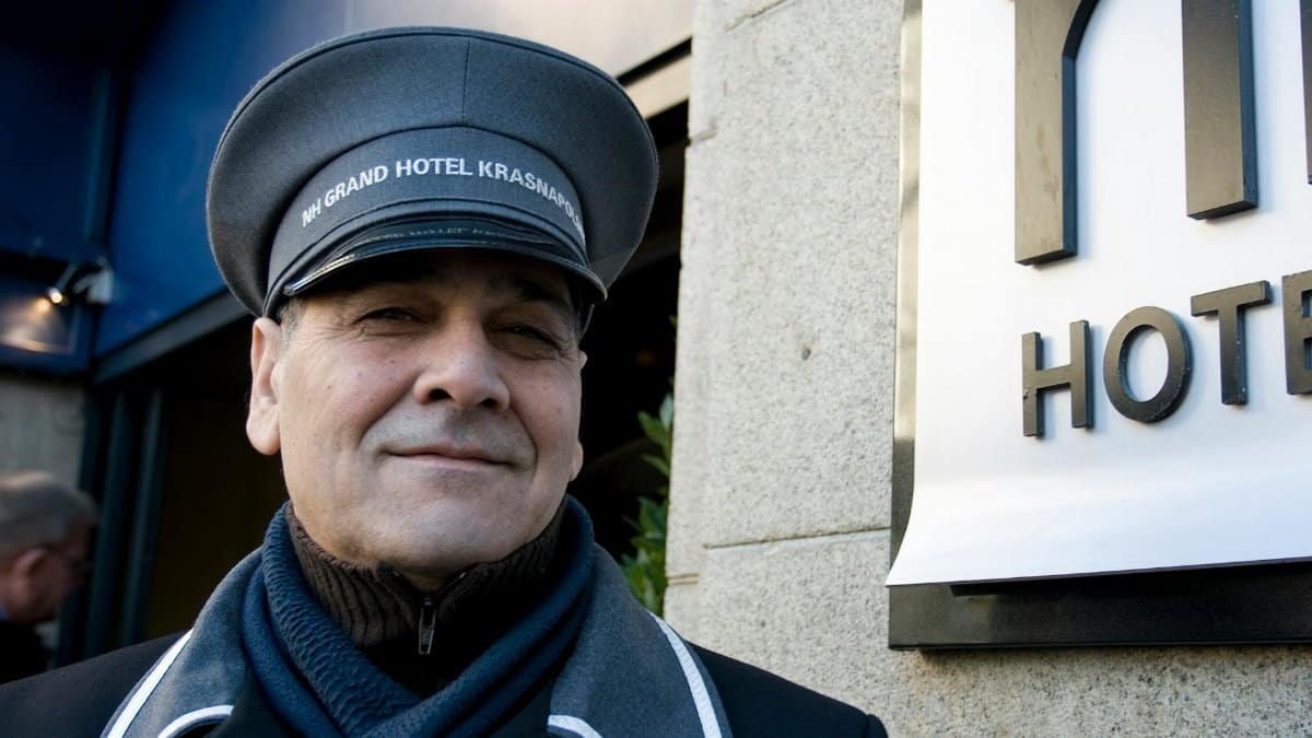 Charming doorman at NH Grand Hotel Krasnapolsky, Amsterdam, welcoming guests.