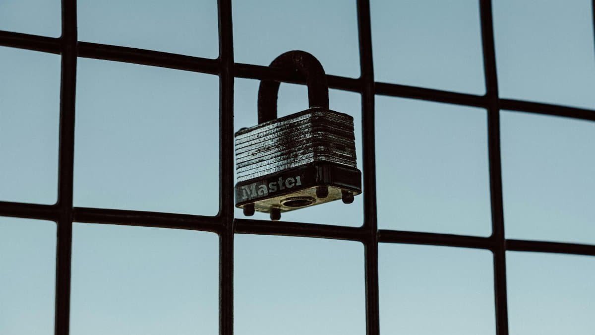 A close-up of a padlock securing a wire fence, symbolizing protection and safety.