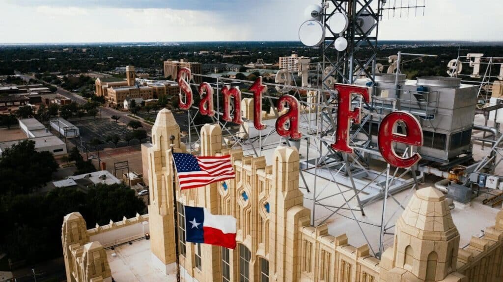 Aerial view of Santa Fe building rooftop with American and Texas flags in Amarillo, Texas.
