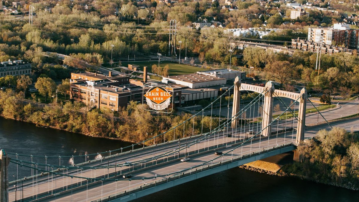 Aerial view of Minneapolis showcasing the Grain Belt Beer sign and a bridge over the Mississippi River.