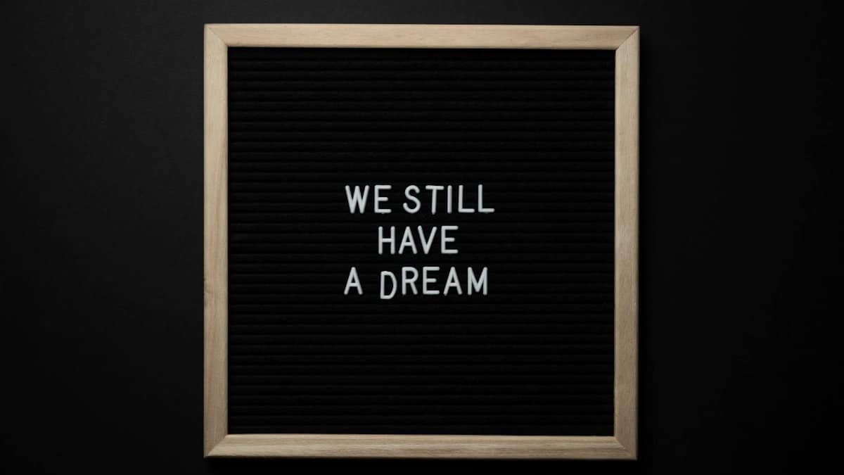 A black letterboard featuring the phrase 'We Still Have a Dream' symbolizing hope and unity.