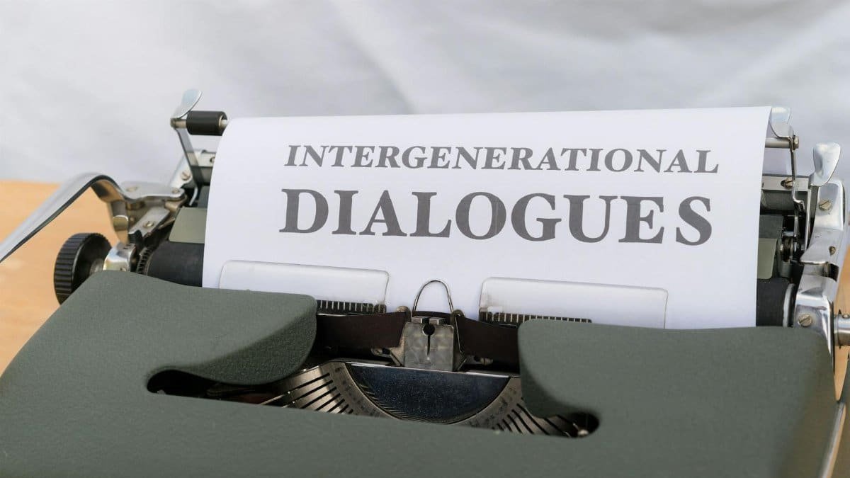 Close-up of a vintage typewriter with a sheet labeled 'Intergenerational Dialogues.'