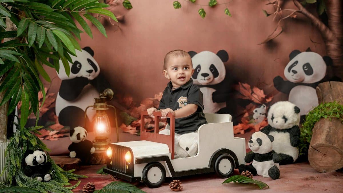 A cute baby plays in a panda-decorated indoor setting, creating a joyful atmosphere.