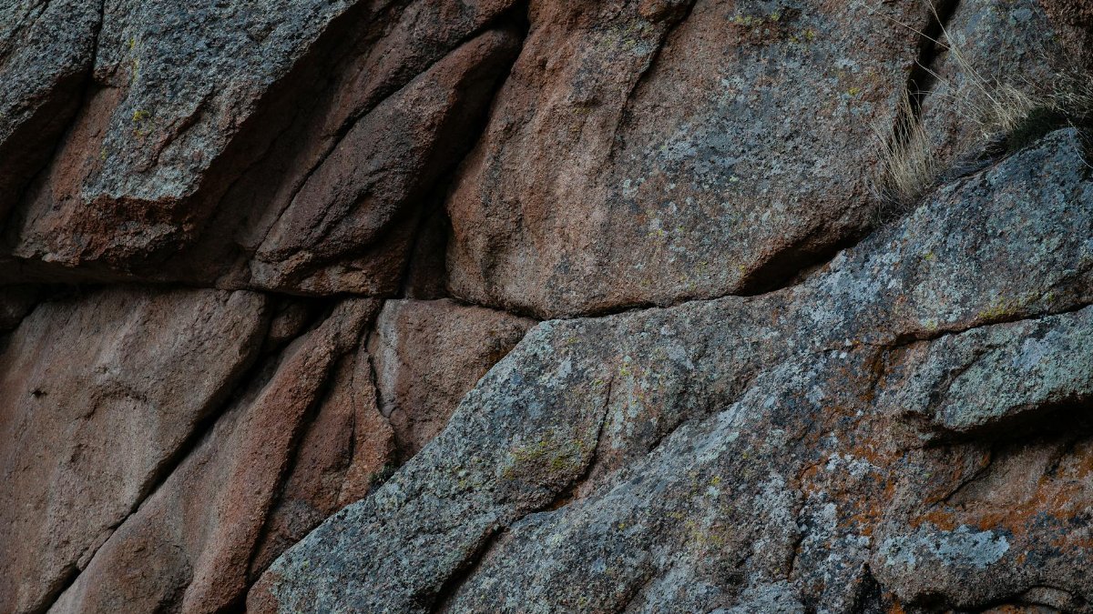 Detailed view of a rugged granite rock surface showing textures and patterns.