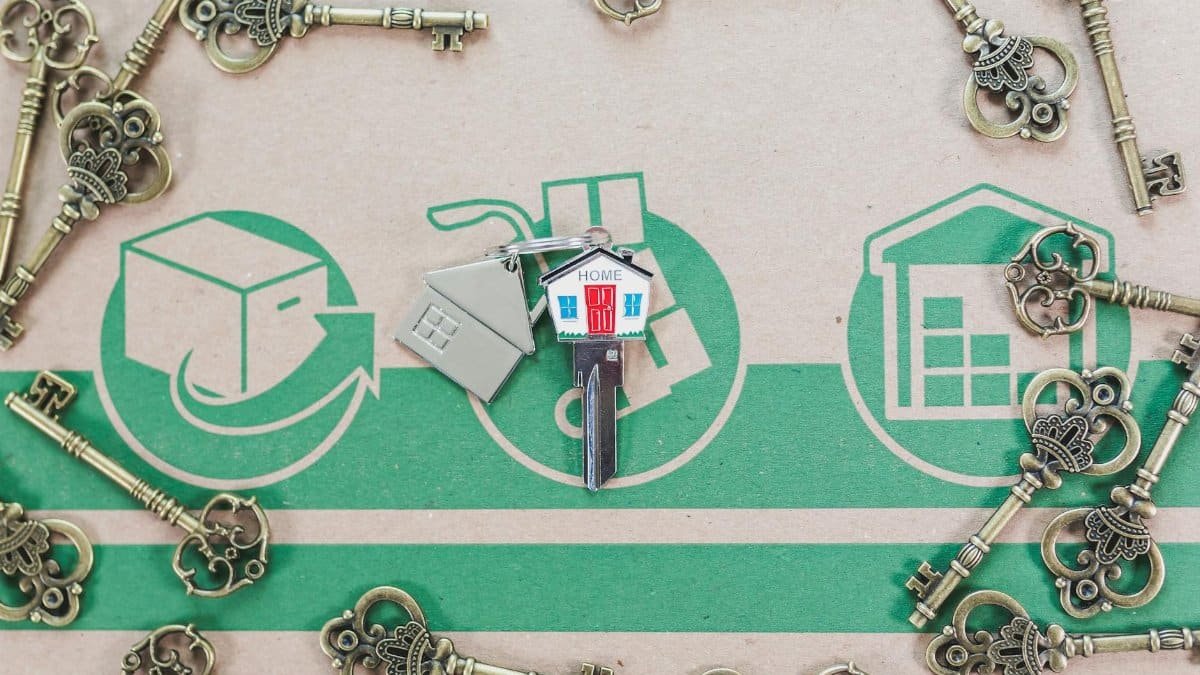 A collection of vintage keys with a modern house key symbolizing real estate investment.