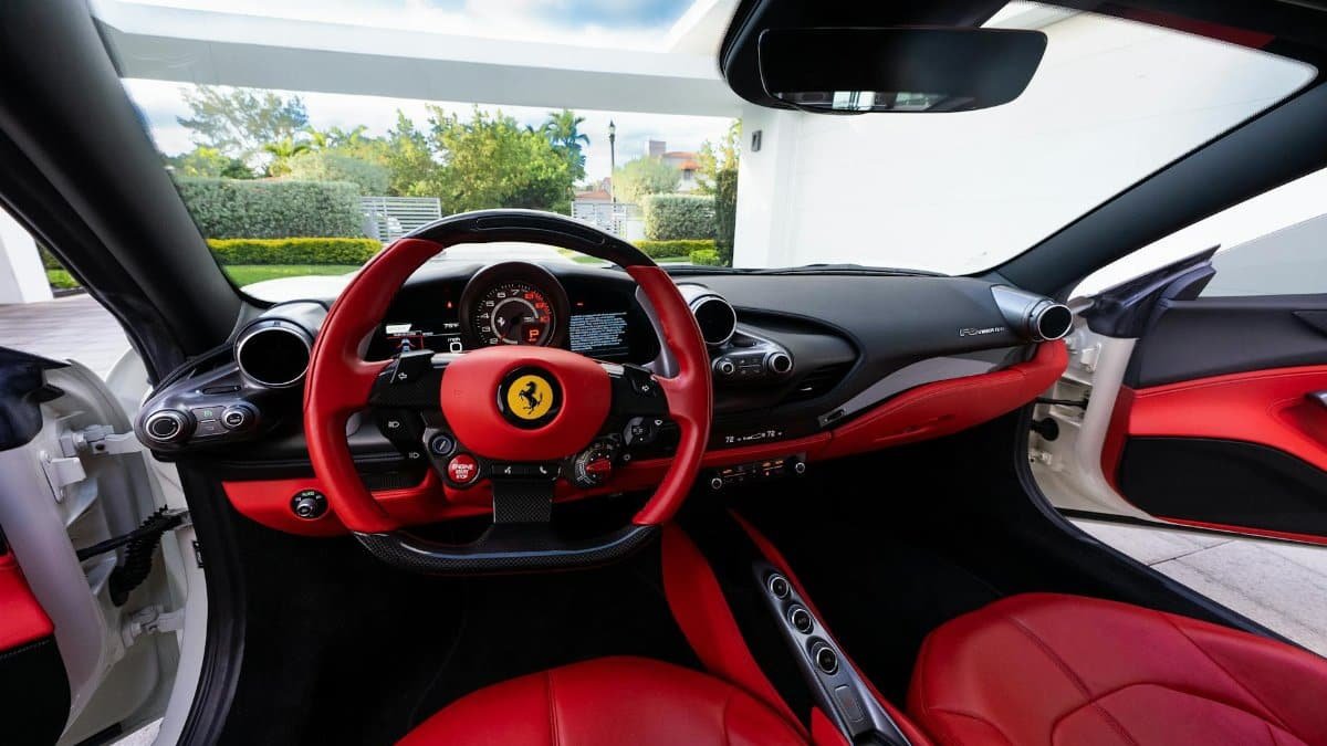 Explore the luxury interior of a high-end sports car, featuring red leather seats and sleek design.