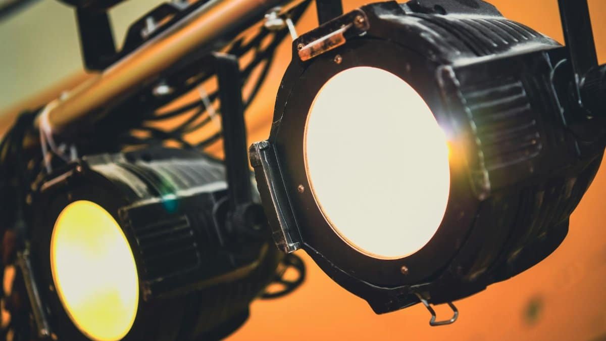 Detailed view of illuminated stage spotlights casting soft warm light