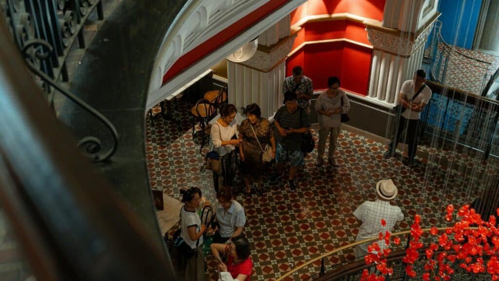 Tourists explore a vibrant indoor historic site in Sydney, Australia.