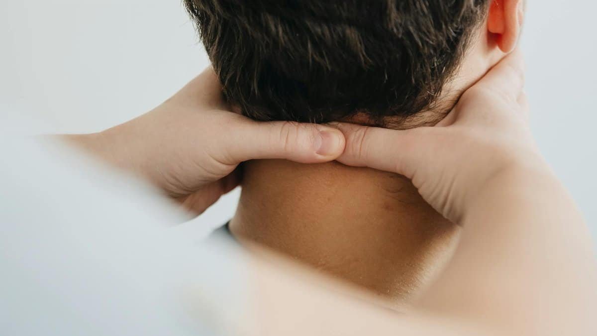 Close-up of a therapist massaging a patient's neck for pain relief and relaxation.