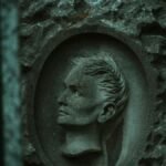 A carved stone relief of a human face captured in dim lighting, adds depth to its ancient, rustic feel.