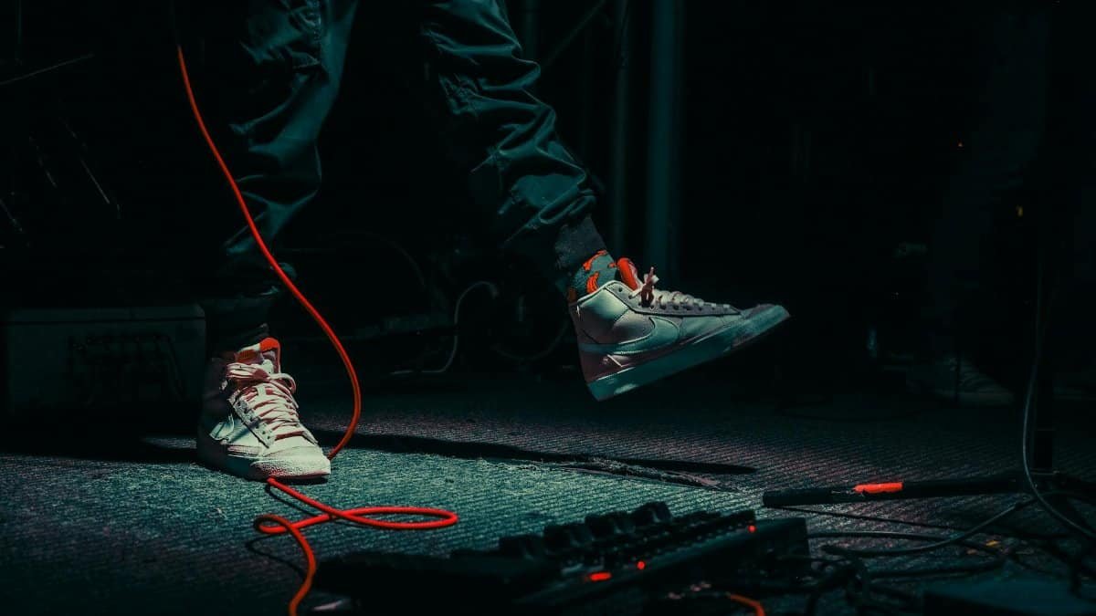 Energetic close-up shot of sneakers at a live concert in Ankara, capturing rock band vibe.