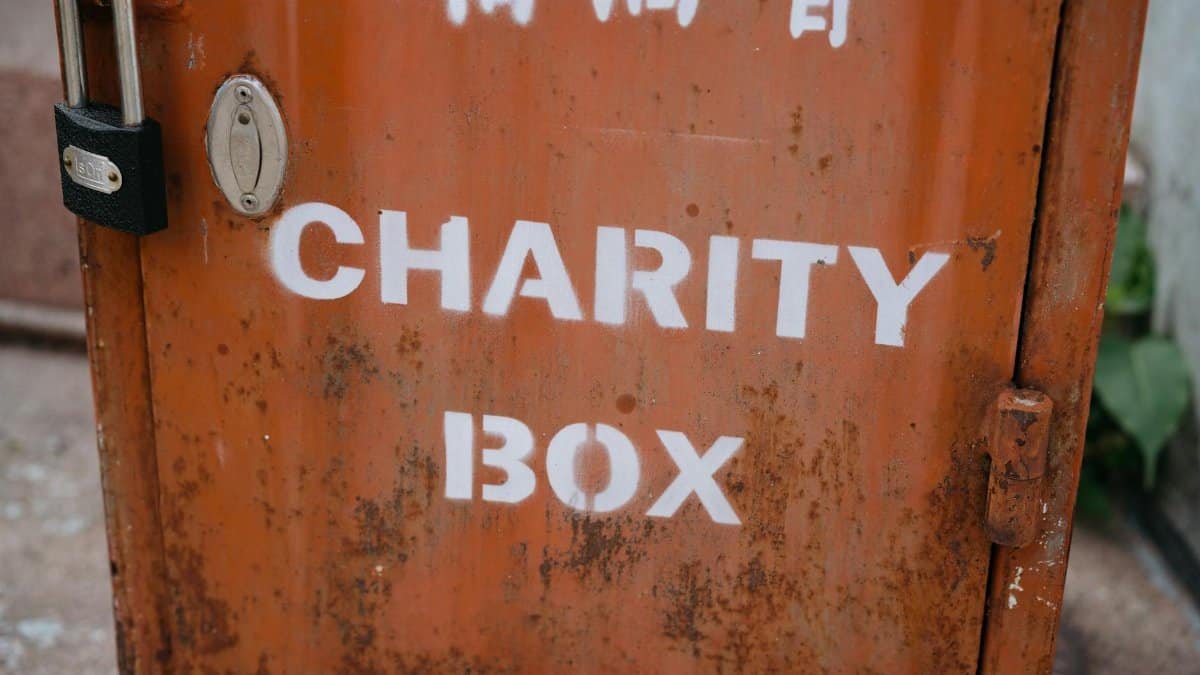 A weathered charity box with a padlock, symbolizing public contribution and community aid.