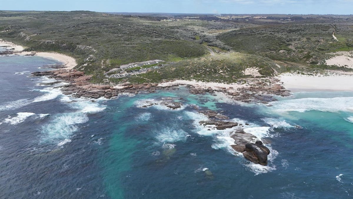 Stunning aerial shot of Western Australia's rocky coastline with clear turquoise waters and sandy beaches.