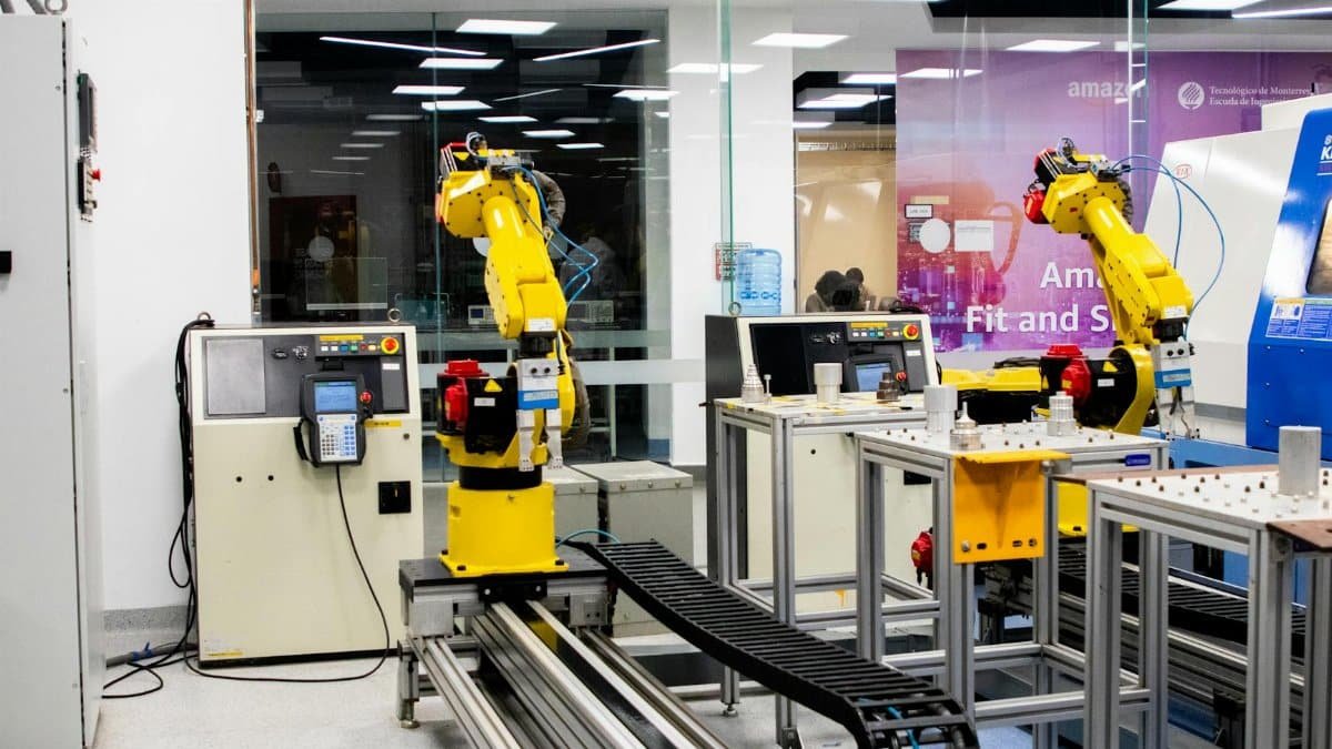 Robotic arms in action within a modern industrial control room setting, showcasing technology and production.