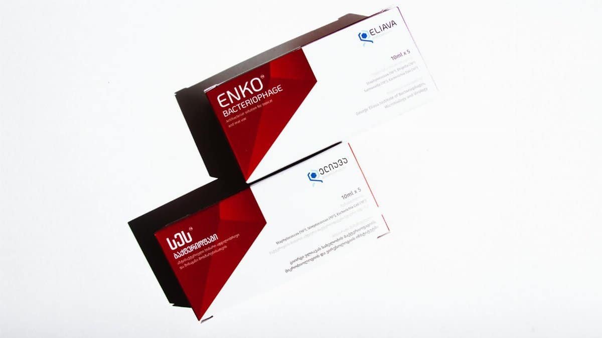 Boxes of bacteriophage medication with red and white design on a white background.