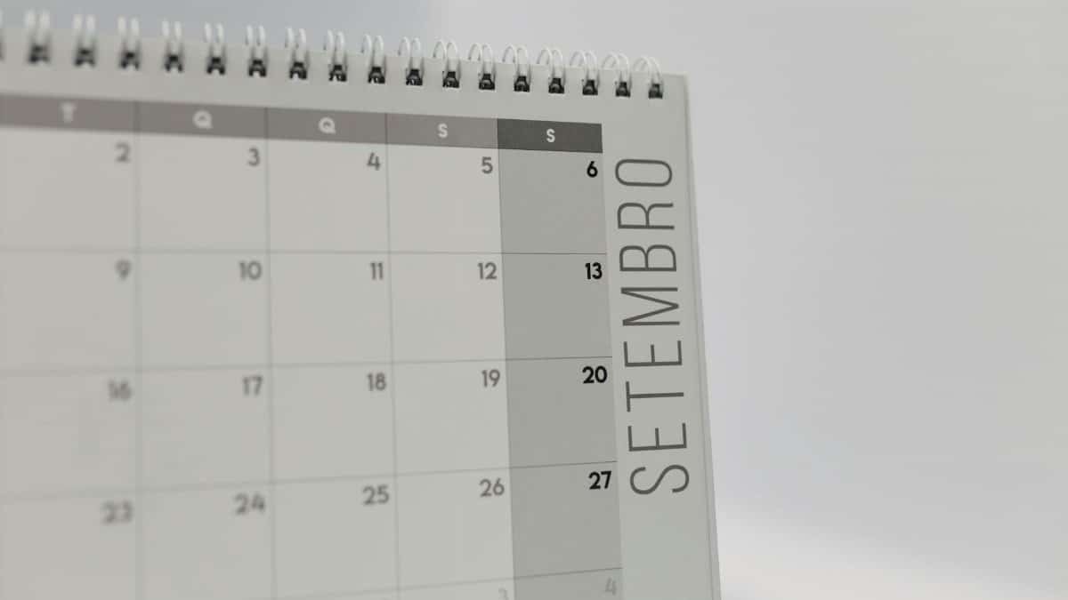 A desk calendar displaying the month of September with a spiral binding, in a minimalist design.
