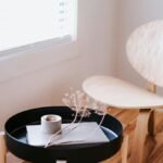 Elegant Japandi style room with a wooden chair, round table, and decorative items.