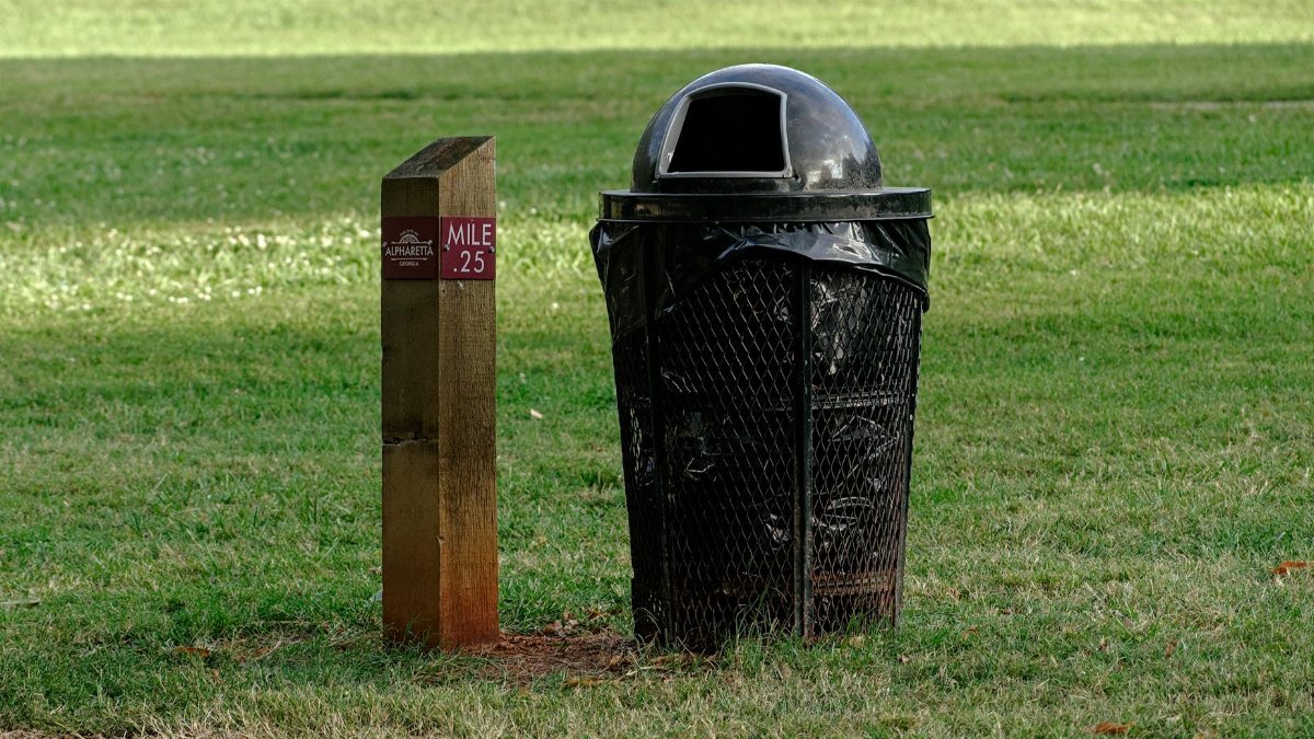 Park scene featuring a trash can and mile marker at Alpharetta, Atlanta.
