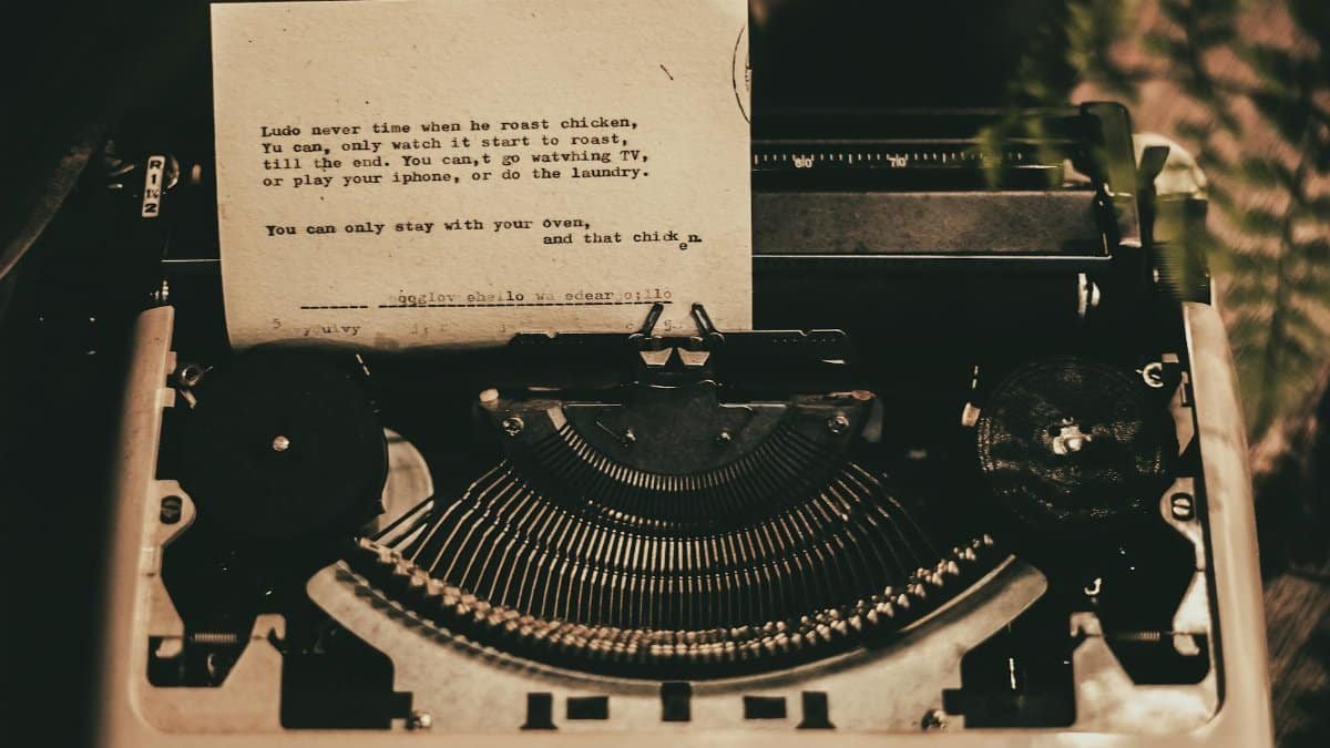 An antique typewriter displaying a typed poem in a nostalgic sepia tone.