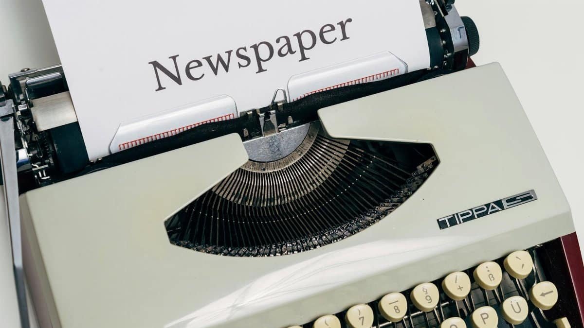 A close-up image of a classic vintage typewriter with a paper labeled 'Newspaper'.