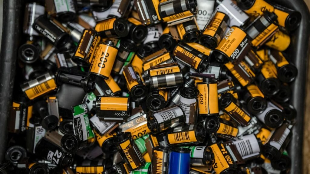 A vibrant collection of assorted 35mm camera film rolls showcasing the nostalgia of analog photography.