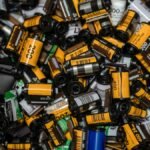 A vibrant collection of assorted 35mm camera film rolls showcasing the nostalgia of analog photography.