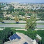 Aerial view showing suburban houses with solar panels, showcasing clean energy.