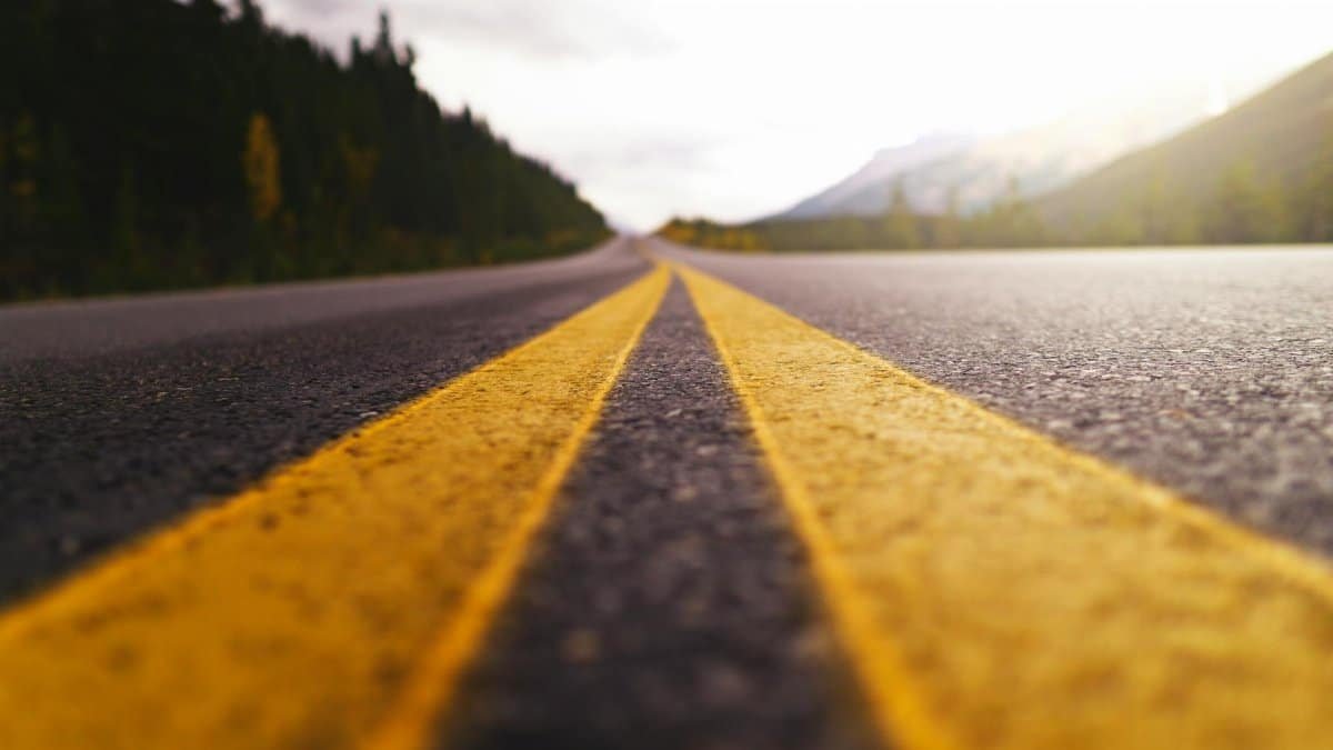 A dramatic view of a road leading through Banff National Park capturing the essence of travel and adventure.
