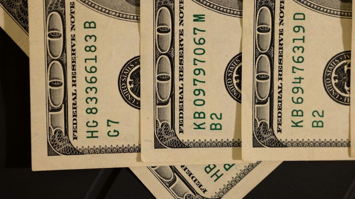 Detailed close-up shot of US dollar bills displaying serial numbers and Federal Reserve details.