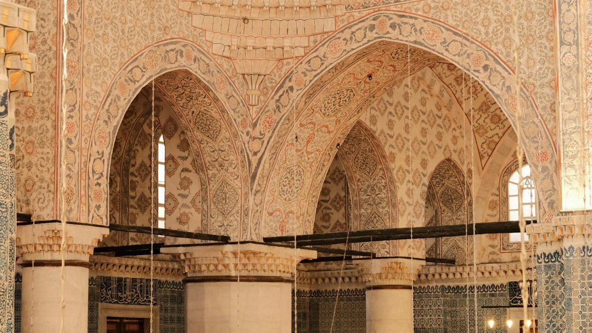 Explore the ornate interior of a mosque showcasing stunning Islamic architectural designs and patterns.